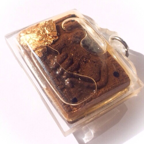 The front face of the amulet, displays the image of a Mouse feeding from a cats breast