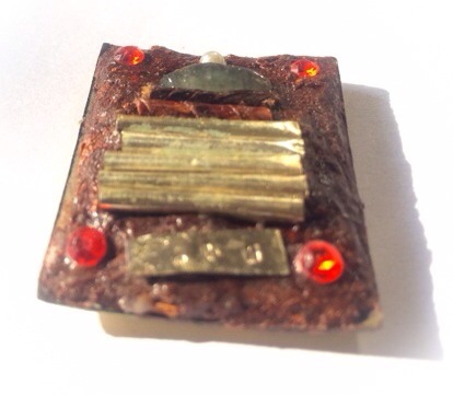 The rear face of the amulet is covered with Muan Sarn Sacred Powders, and has been stuffed full of Sacred Ploi Sek Maha Pokasap gems, and silver Takrut spells