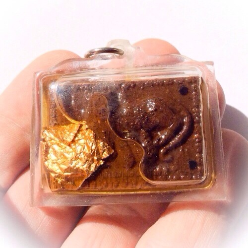 cat feeding a mouse sacred powder amulet, in sacred oils. this example is one of the Ongk Kroo Masterpiece Versions