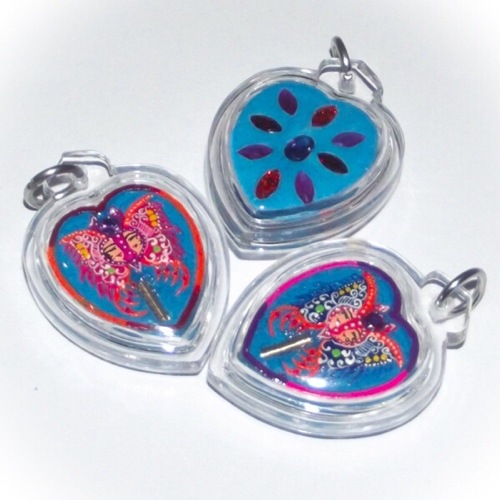 Taep Jamlaeng Butterfly King Amulet blue powders hand pajnted heart shaped amulets with Ploi Sek Maha Pokasap - from Kroo Ba Krissana Intawano